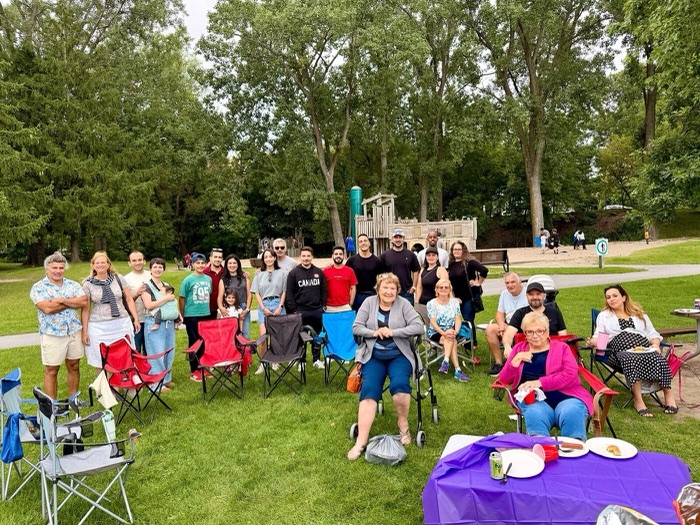 A big group of clients gathered in the park for the client appreciation event