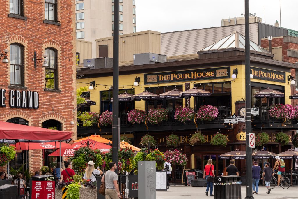 Outdoor patios and flower-lined balconies on a downtown Ottawa street