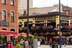 Outdoor patios and flower-lined balconies on a downtown Ottawa street