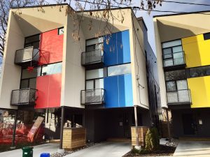 Modern infill homes with coloured panels in Hintonburg