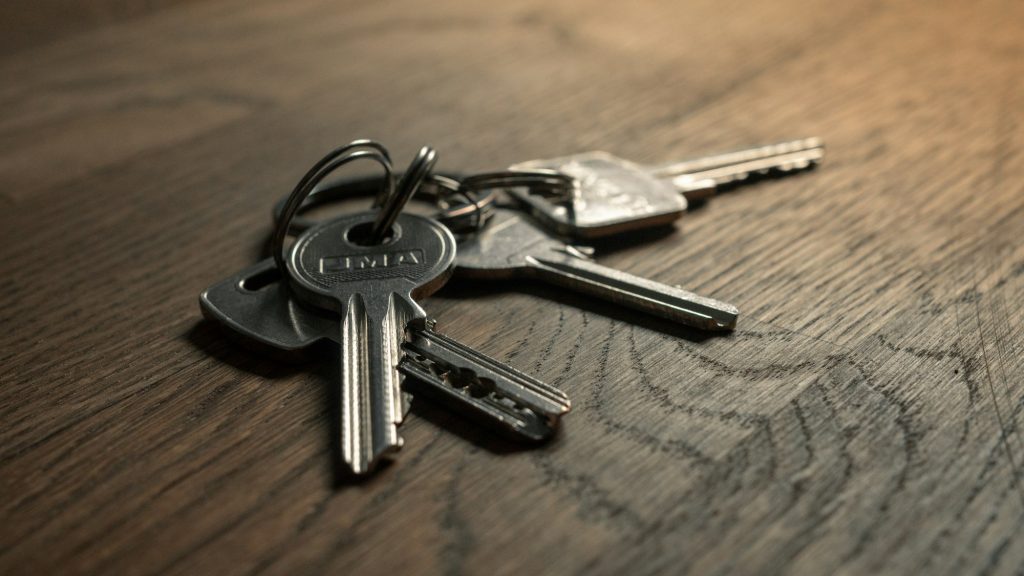 A set of keys resting on a wooden table